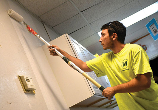 Field Supervisor Nicolas Paterniti of Moreno & Associates, Inc. gives new life to an office with a fresh coat of paint. 